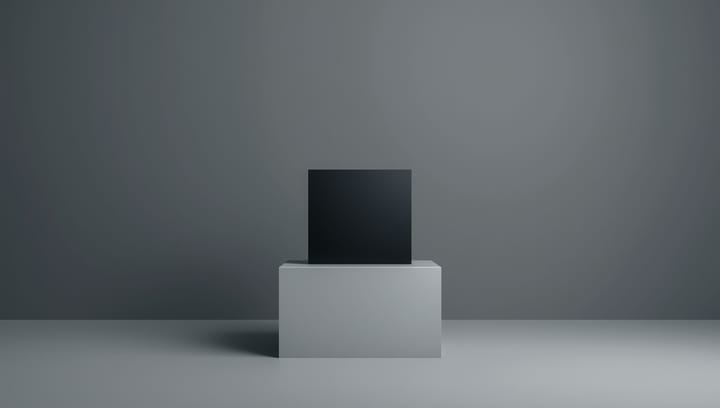 A perfect, simple, matte black cube on a white pedestal.